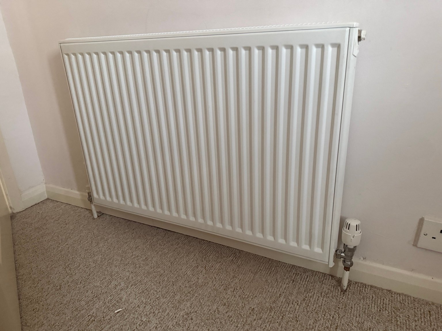 New panel radiator installation with thermostatic radiator valve